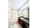 Bathroom featuring tile floors, a vanity, a large mirror, and a soaking tub at 128 Brushcreek Dr, Sanford, FL 32771