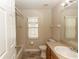 Bathroom with a large vanity, neutral color palette, tiled floor, and window for natural light at 128 Brushcreek Dr, Sanford, FL 32771