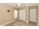 Spare bedroom features tile flooring, ceiling fan, closet, and a window at 128 Brushcreek Dr, Sanford, FL 32771