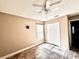 Neutral bedroom with ceiling fan, tiled floor and ample natural light at 128 Brushcreek Dr, Sanford, FL 32771