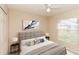 Bright bedroom with soft gray accents, a large window, and neutral decor at 128 Brushcreek Dr, Sanford, FL 32771