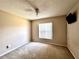 Bedroom with ceiling fan, large window, and neutral walls at 128 Brushcreek Dr, Sanford, FL 32771