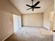 A spare bedroom with plush carpeting, a ceiling fan, and a sliding glass door at 128 Brushcreek Dr, Sanford, FL 32771