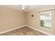 Spare bedroom featuring tile floors, a window and a ceiling fan at 128 Brushcreek Dr, Sanford, FL 32771