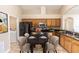 A lovely dining table sits in this kitchen/dining combo with oak cabinets and black appliances at 128 Brushcreek Dr, Sanford, FL 32771