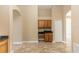 Kitchen featuring light-colored tile flooring, light-colored walls, and wood cabinetry at 128 Brushcreek Dr, Sanford, FL 32771