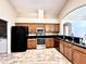 Kitchen with stainless steel appliances, wood cabinets, tile floors, and granite counters at 128 Brushcreek Dr, Sanford, FL 32771