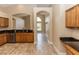 Kitchen with stainless steel dishwasher and sink plus granite countertops and light-colored tile floors at 128 Brushcreek Dr, Sanford, FL 32771