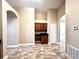 Kitchen with tile floor, built-in desk area, wood cabinets, and views of the living area at 128 Brushcreek Dr, Sanford, FL 32771