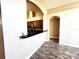The open-concept kitchen features dark countertops and wood cabinetry at 128 Brushcreek Dr, Sanford, FL 32771