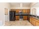 A kitchen with oak cabinets, black appliances, and dining table at 128 Brushcreek Dr, Sanford, FL 32771