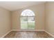 Living room with a large arched window overlooking a manicured front yard at 128 Brushcreek Dr, Sanford, FL 32771