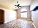 Open-plan living room features tile flooring, a ceiling fan, and a large window at 128 Brushcreek Dr, Sanford, FL 32771