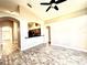 An open-plan living room features tile flooring and an open-concept kitchen at 128 Brushcreek Dr, Sanford, FL 32771