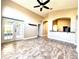 Bright open-plan living room with tile flooring, ceiling fan, and outdoor access at 128 Brushcreek Dr, Sanford, FL 32771