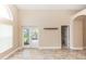 Living room with light-colored tile floors, white trim, and French doors leading to an outdoor space at 128 Brushcreek Dr, Sanford, FL 32771