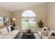 Bright and airy living room featuring a large arched window and neutral tones at 128 Brushcreek Dr, Sanford, FL 32771