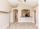 Spacious living room with an open floor plan that flows into the kitchen featuring tile floors and archways at 128 Brushcreek Dr, Sanford, FL 32771