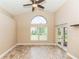 Living room with a ceiling fan and a large arched window letting in plenty of natural light at 128 Brushcreek Dr, Sanford, FL 32771