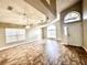 Bright living room with high ceilings, tile floors, and large arched window letting in natural light at 128 Brushcreek Dr, Sanford, FL 32771