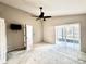 Spacious main bedroom with plush carpeting, a ceiling fan, and sliding glass door at 128 Brushcreek Dr, Sanford, FL 32771