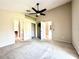Spacious main bedroom featuring plush carpeting, a ceiling fan, and ample closet space at 128 Brushcreek Dr, Sanford, FL 32771