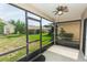 Screened patio with a ceiling fan offers a comfortable space to enjoy the backyard view at 128 Brushcreek Dr, Sanford, FL 32771