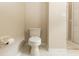 Close up of the toilet area that features a tile floor and a door nearby at 128 Brushcreek Dr, Sanford, FL 32771