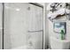 Marble walled shower with glass door in bathroom with white toilet and towel rack at 140 Elgin Blvd, Davenport, FL 33897