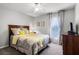 This bedroom offers a ceiling fan and a sunny window with beautiful curtains at 140 Elgin Blvd, Davenport, FL 33897
