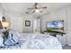 Comfortable bedroom features a ceiling fan, large tv, and closet at 140 Elgin Blvd, Davenport, FL 33897
