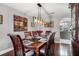 Elegant dining room featuring hardwood floors, modern lighting, and a view of the kitchen at 140 Elgin Blvd, Davenport, FL 33897