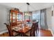 Elegant dining room featuring hardwood floors, modern lighting, and a large china cabinet at 140 Elgin Blvd, Davenport, FL 33897