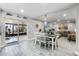 Open concept dining room with sliders to screened in lanai and views of living area and kitchen at 140 Elgin Blvd, Davenport, FL 33897