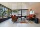 Relaxing enclosed patio with comfortable wicker seating, a coffee table, and decorative accents for outdoor enjoyment at 140 Elgin Blvd, Davenport, FL 33897