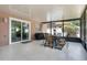 Cozy enclosed patio features neutral decor, a dining table, and a decorative outdoor rug for relaxing and entertaining at 140 Elgin Blvd, Davenport, FL 33897