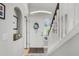 Welcoming foyer with a decorative front door, staircase, and bright natural light at 140 Elgin Blvd, Davenport, FL 33897