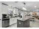 Modern kitchen featuring white cabinets, granite countertops, stainless appliances, and center island at 140 Elgin Blvd, Davenport, FL 33897