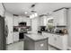 Modern kitchen featuring white cabinets, granite countertops, stainless steel appliances, and center island at 140 Elgin Blvd, Davenport, FL 33897