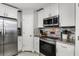 Gourmet kitchen featuring stainless steel appliances, modern cabinetry, and stylish backsplash at 140 Elgin Blvd, Davenport, FL 33897