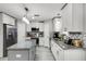 Updated kitchen featuring stainless appliances, gray island, mosaic backsplash and lots of cabinets at 140 Elgin Blvd, Davenport, FL 33897