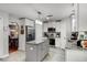 Modern kitchen with stainless appliances, granite countertops, center island, and adjacent dining area at 140 Elgin Blvd, Davenport, FL 33897