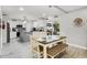 Bright kitchen with white cabinetry, stainless appliances, and adjacent dining area with natural light at 140 Elgin Blvd, Davenport, FL 33897