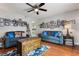 Open living room featuring hardwood floors, cozy seating and ample natural light at 140 Elgin Blvd, Davenport, FL 33897