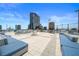 Stylish rooftop patio with comfortable lounge seating and grilling area, ideal for entertaining and relaxation with city views at 150 E Robinson St # 717, Orlando, FL 32801