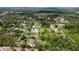 Expansive aerial view of multiple single-Gathering homes surrounded by lush landscaping and mature trees at 15305 Shady Ln, Tavares, FL 32778