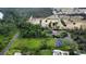 Wide aerial shot capturing a large lot with multiple buildings, lush trees, and maintained lawns at 15305 Shady Ln, Tavares, FL 32778