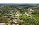 An aerial view of a property with red boundary lines surrounded by lush landscaping and mature trees at 15305 Shady Ln, Tavares, FL 32778