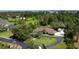 Expansive aerial view of a single-Gathering home with lush landscaping and private driveway at 15305 Shady Ln, Tavares, FL 32778