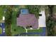 Bird's-eye view featuring a backyard pool, manicured lawn, and landscaped areas around a private residence at 15305 Shady Ln, Tavares, FL 32778